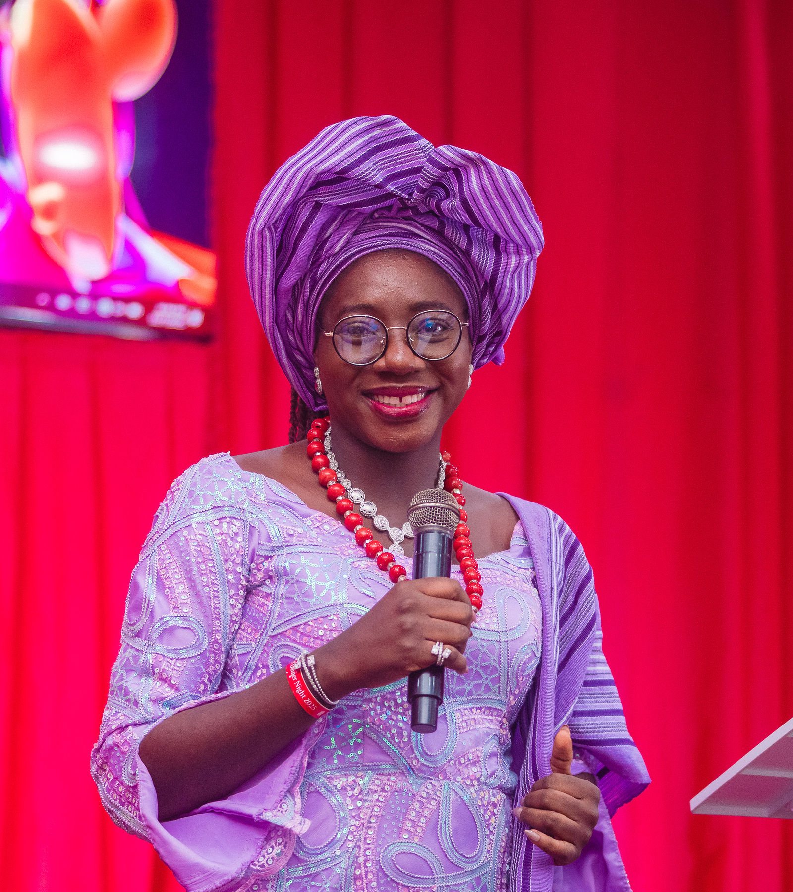 A speaker in a purple gele, used to show cropping